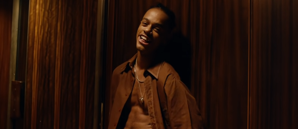 A shot from the video for "Smile", by Jungle, showing Che Jones smiling.